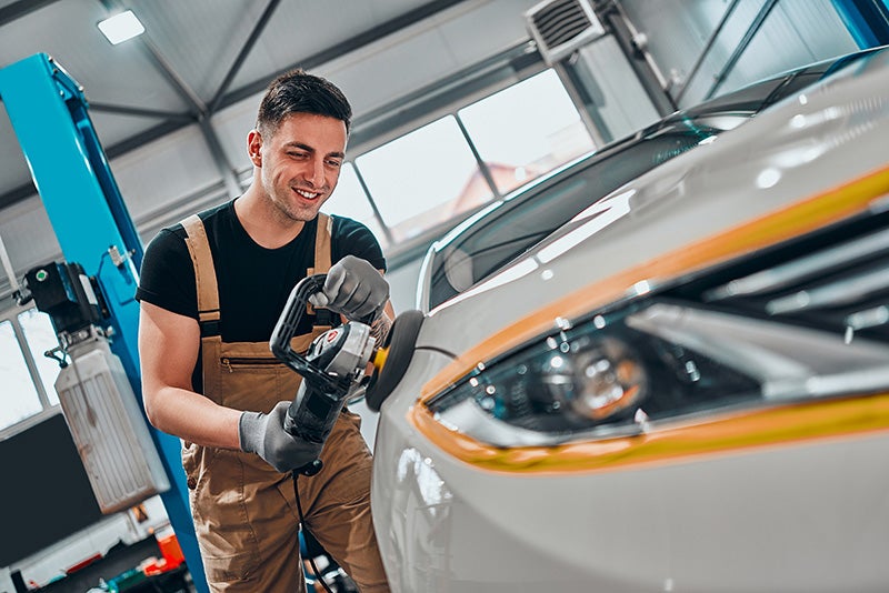 Technician working on car details